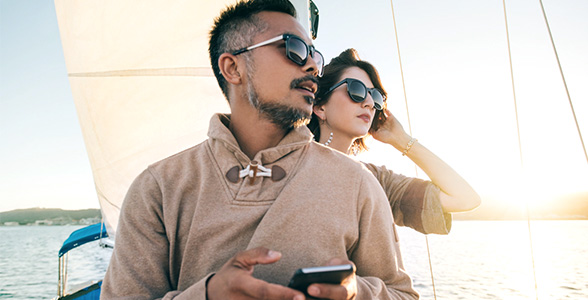 Investor couple accessing money via phone